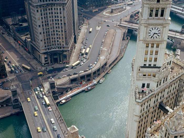 Illinois, 1950s: Perched atop the City of Broad Shoulders, tourists gaze down on the Chicago River from the roof of the Tribune Building.