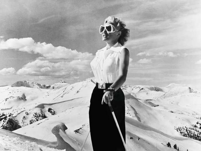 Colorado, 1953: Taking a pause from ski-in-the-sun fun, a woman peers across the snowy Rockies. In the 1950s, Colorado became a winter sports capital for a nation with more time for health and leisure.