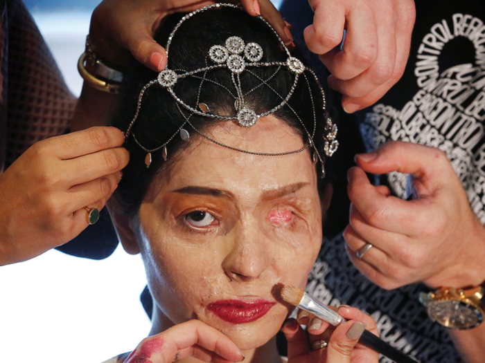 Indian model Reshma Quereshi has make up applied before walking to present Indian designer Archana Kochhar