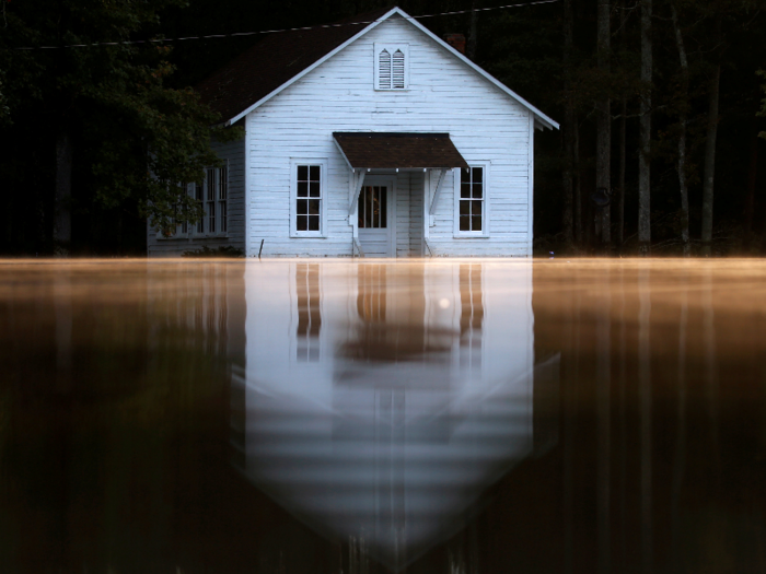 Mist rises off the water as a flooded building is pictured after Hurricane Matthew passes Lumberton, North Carolina.