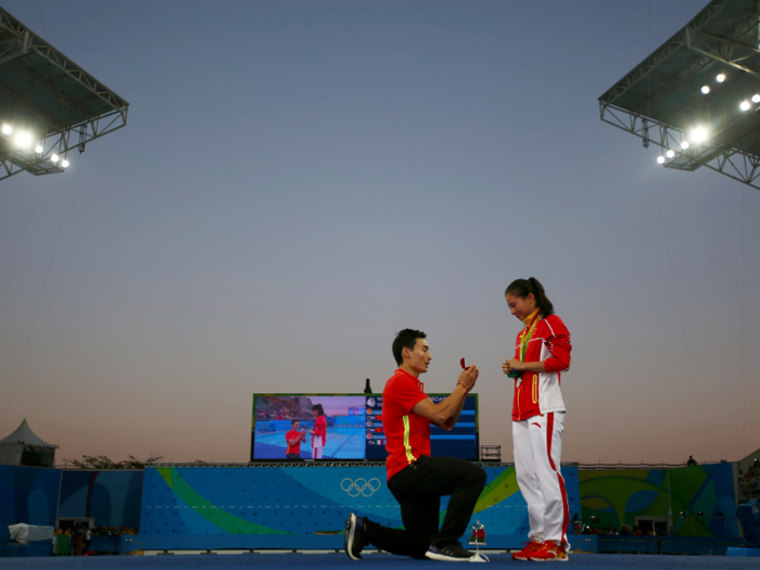 He Zi of China receives a marriage proposal from Olympic diver Qin Kai of China after the medal ceremony. She accepted Qin