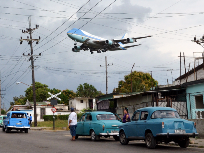 Air Force One carrying President Barack Obama and his family flies over a neighborhood of Havana as it approaches the runway to land at Havana