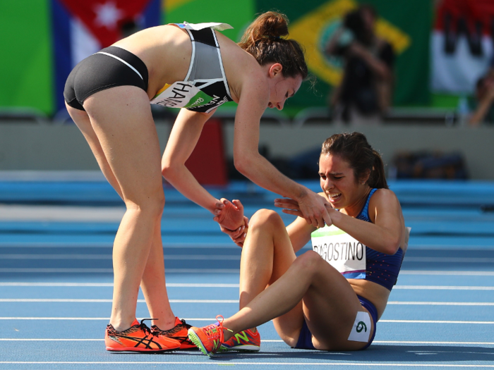 Nikki Hamblin of New Zealand stops running during a race to help fellow competitor Abbey D