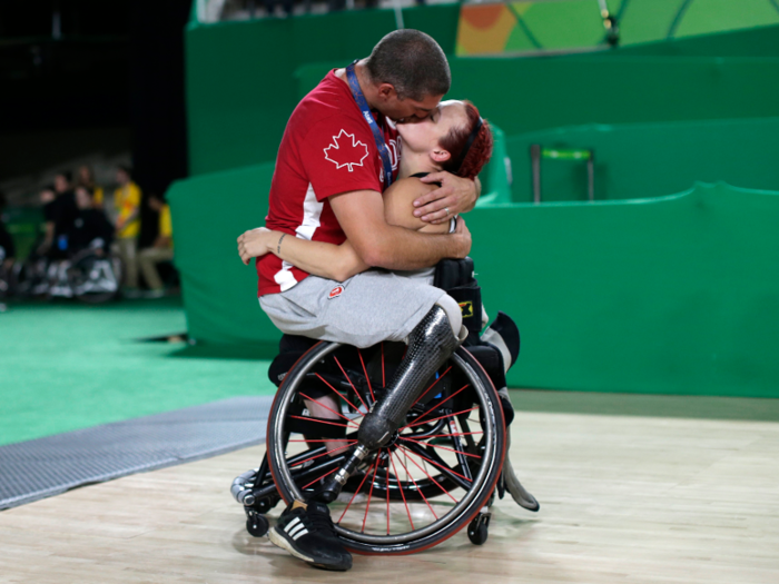 Canadian wheelchair basketball players Adam Lancia and Jamey Jewells embrace at the Rio Paralympics.