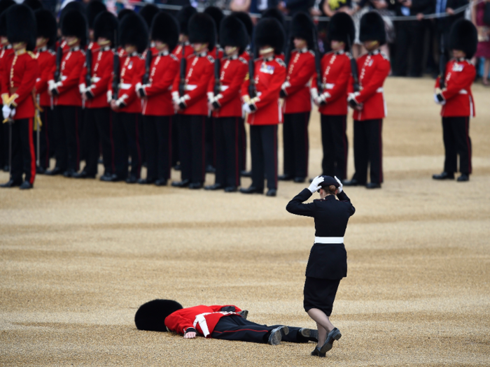 A Guardsman faints at Horseguards Parade for the annual Trooping the Colour ceremony in central London.