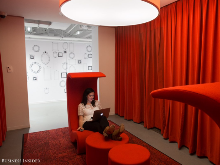 The office has plenty of other little surprises, like this red lounge. "Concealed behind the curtains are elevator doors that no longer open onto the floor and historic marble panels that must remain intact," Lauren Foley, IA Interior Architects