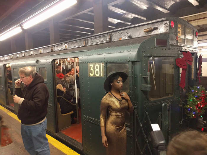 While the train was stopped, people dressed in anachronistic clothing posed for photos next to the antique train cars: