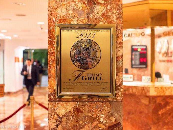 The atrium, open to the public, is festooned with unspeakable amounts of fleshy pink marble and flashy gold (or maybe bronze) plating. Dotting the walls of this marble and gold cenote are plaques bestowed upon the numerous Trump brands by the American Academy of Hospitality Sciences — an awards group that has questionable ties to Trump.