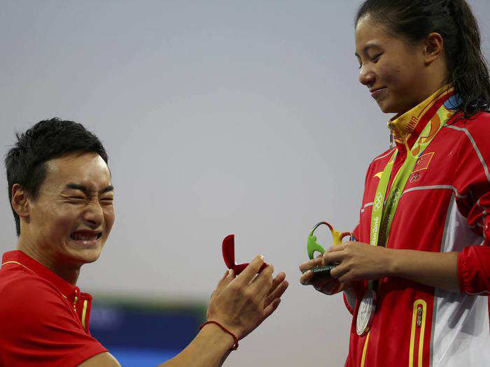 He Zi of China receives a marriage proposal from Olympic diver Qin Kai of China after the medal ceremony. She accepted Qin