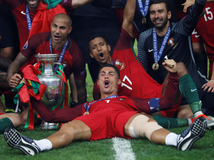 Cristiano Ronaldo celebrates with his Portuguese teammates and the trophy after winning the UEFA Euro 2016.