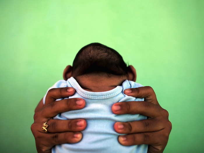 Jackeline, 26, holds her son, who is four months old and born with microcephaly, in front of their house in Brazil in February. Microcephaly, abnormal smallness of the head, has been linked to the Zika virus, which spread rapidly through South America and other parts of the world in 2016.