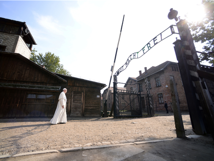Pope Francis walks through the notorious gate at Auschwitz