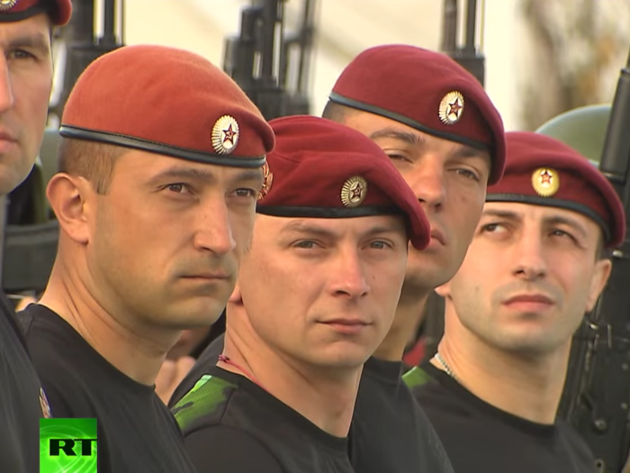Their counterparts in Russia do much the same, though their head gear is crimson. Russia