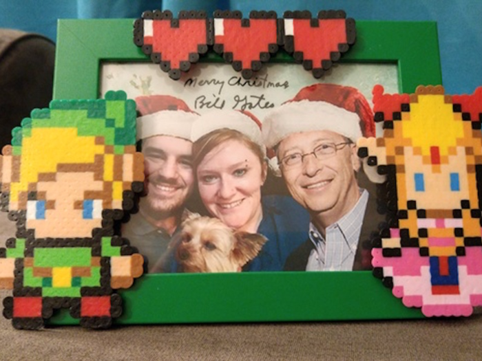 But the funniest gift in the box was a beaded Zelda-themed picture frame (he knew from her profile that she loves to bead). Inside the frame was a photo of her family with himself photoshopped in. She wrote, "The picture in it is just the best...he used my profile picture on here of me, my husband, and my dog, PHOTOSHOPPED HIMSELF IN, and put Santa hats on all of us! Come on now, that is the cutest thing!"