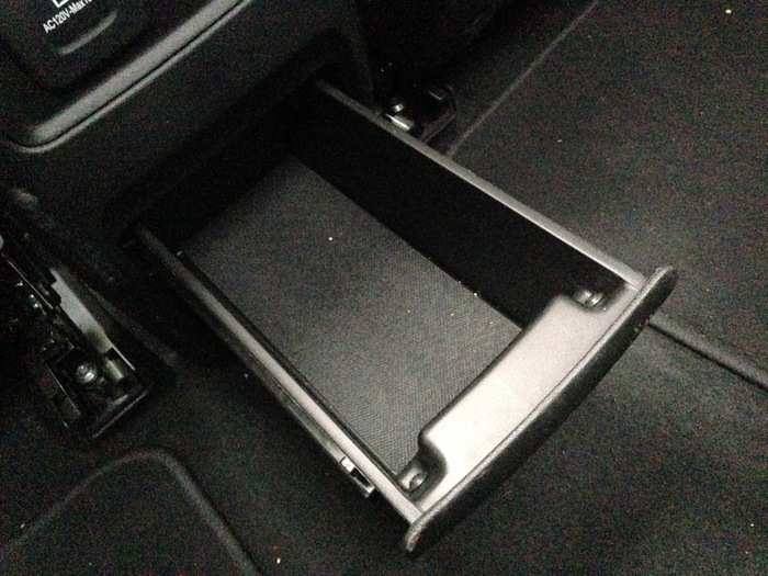 The second row also has this large pull-out tray that can serve as an extra-large cupholder.