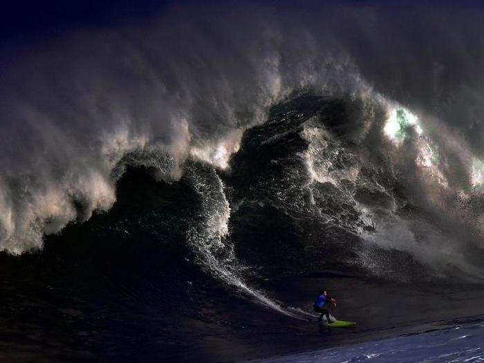 A surfer rides a large wave at El Bocal during the Vaca Gigante (Big Cow) giant wave surf competition in Santander, northern Spain, on December 17.