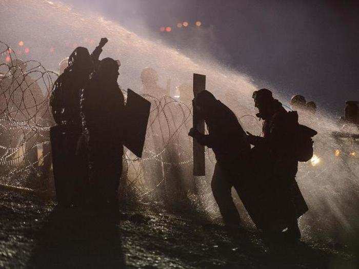 Police use a water cannon on protesters during a protest against plans to pass the Dakota Access pipeline near the Standing Rock Indian Reservation, near Cannon Ball, North Dakota, on November 20.