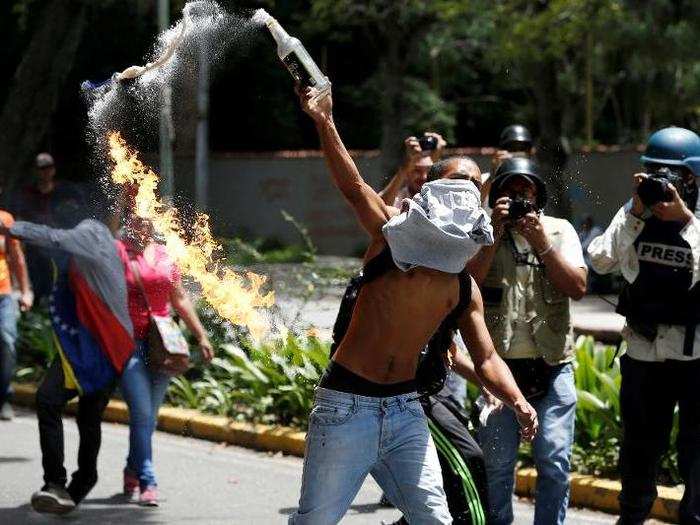 A Molotov cocktail is thrown by a protester during a protest called by university students against Venezuela