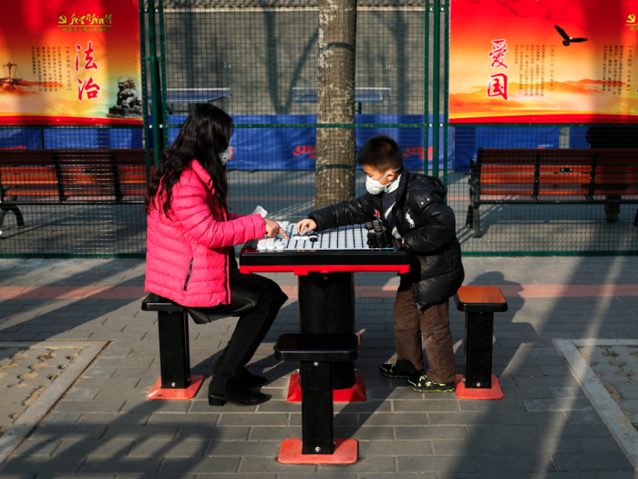 But life must go on. Here a mother and son bond outdoors despite a heavily polluted day in Beijing.