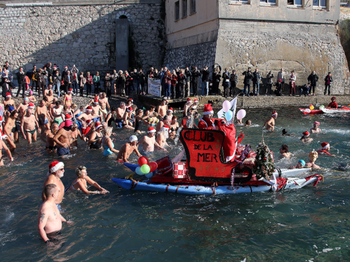 In Nice, France, brave souls wearing Santa Claus caps take a dip in the freezing cold riverbank. The tradition has gone on for 72 years.