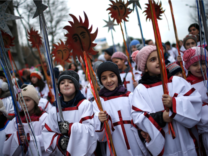 During the Orthodox Christmas, clergy members lead a procession through the streets of Tbilisi, Georgia, where participants give gifts and sweets to children and the needy.