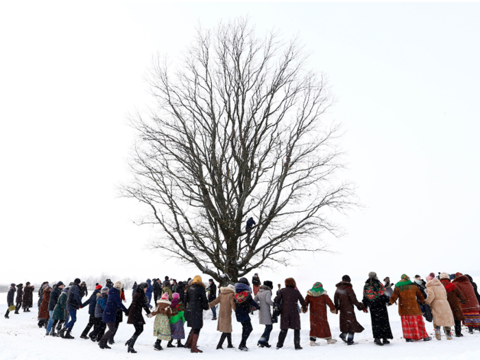 People in the village of Martsiyanauka, Belarus, gather around a tree to mark the end of an ancient pagan holiday known as Kolyada. The rituals are believed to bring a good harvest.