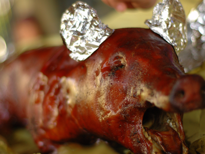 At midnight on Christmas Eve, Filipino Christians dine on massive whole suckling pigs, often featuring a bright yellow ball of cheese in its mouth.