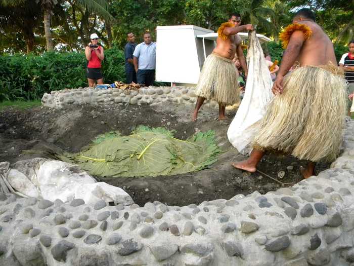 In Fiji, locals dine on banana leaf-wrapped fish, stuffed chicken, and pork made with a "Lovo," an earth oven made with heavy stones, like the one seen below.