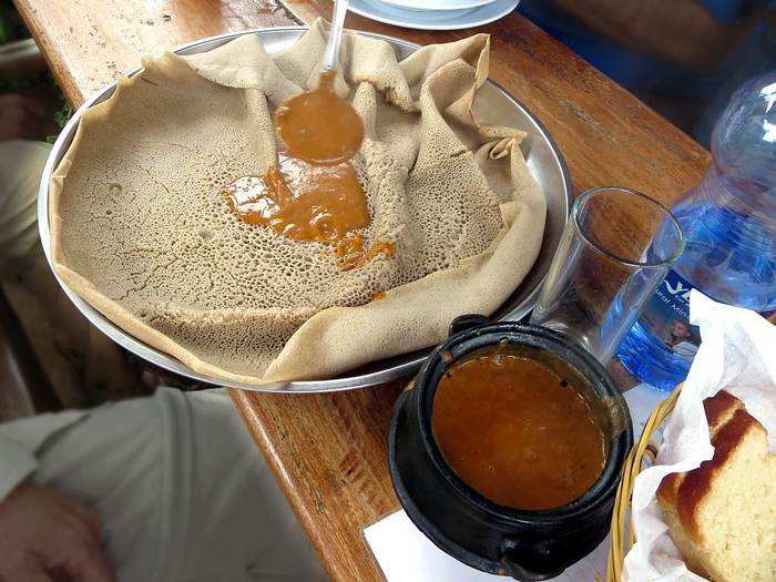 In Ethiopia, locals eat a "doro wat," a chicken stew served with flat bread. Forget the forks and knives, because like with many Ethiopian meals, you eat this with your hands.