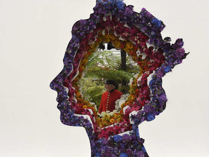 A Chelsea Pensioner posed as he viewed a floral design of Queen Elizabeth at the Chelsea Flower Show in London.