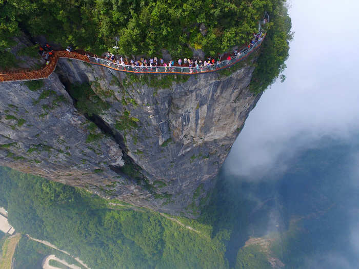 Brave tourists walked on a sightseeing platform in Zhangjiajie, Hunan Province, China.