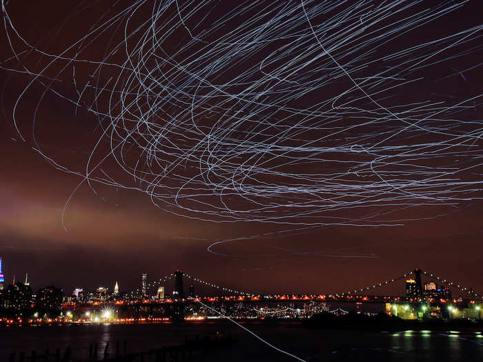 LED lights attached to pigeons left light trails in the sky as part of the "Fly By Night" art installation by Duke Riley above New York.