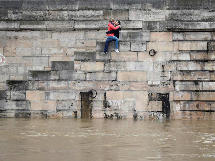 A couple kissed on the bank of the Seine River in Paris as high waters were causing flooding.