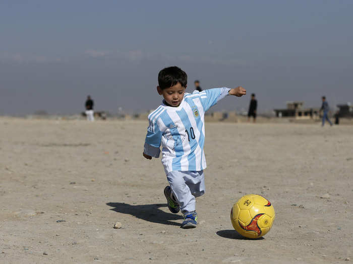 Five-year-old Lionel Messi fan Murtaza Ahmadi wore an Argentina shirt signed by the Barcelona star as he played football in Kabul, Afghanistan.