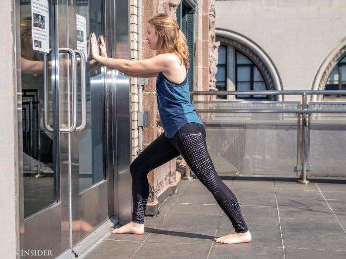 Next, find a wall to do a heel-chord stretch. This requires placing both feet firmly on the floor with the front knee moving into a bend and big toe against the wall. Repeat.