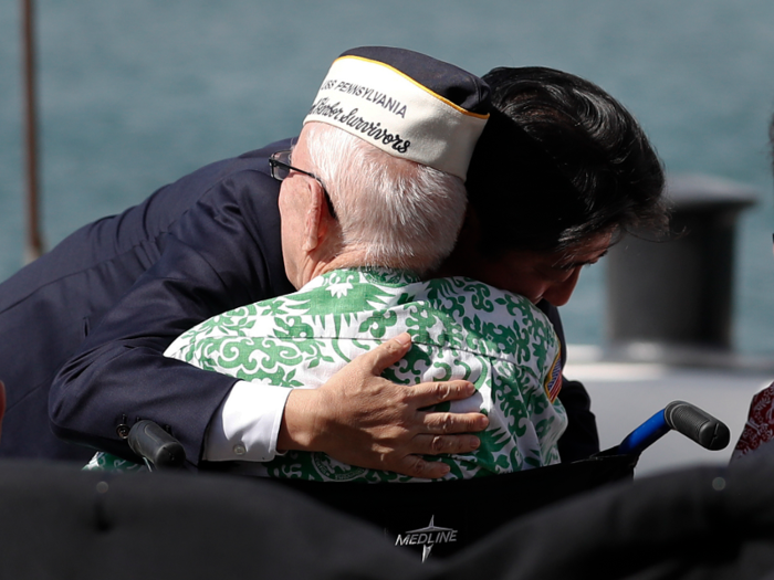 Abe embraces another Pearl Harbor survivor. Abe said he wishes the future generations of Japan and the United States "will continue to remember Pearl Harbor as the symbol of reconciliation."