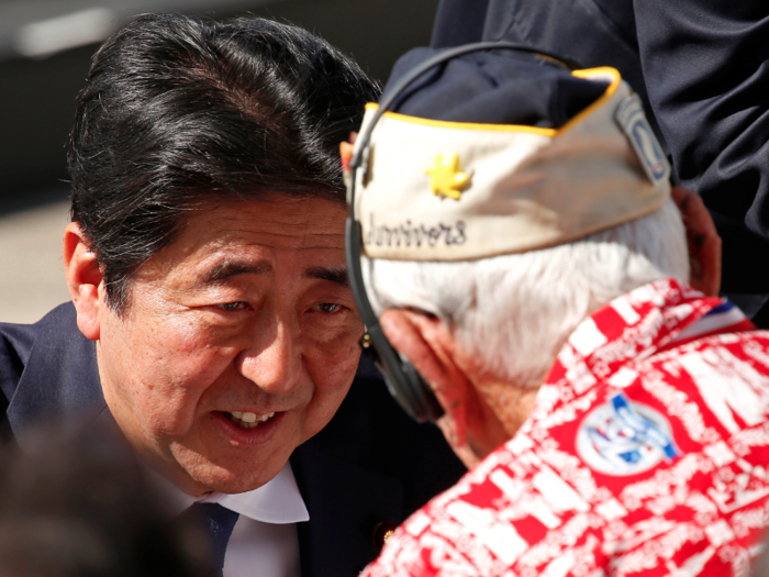 Abe speaks with Pearl Harbor survivor Alfred "Al" Rodrigues who recalled the December 7, 1941 attack. Rodrigues said during a ceremony earlier this month, “we need to do a little more loving in this world instead of fighting.”