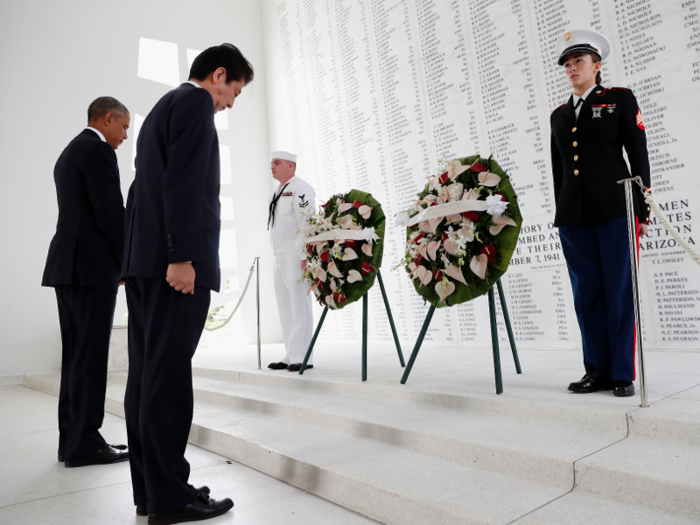 Obama and Abe participate in a wreath-laying ceremony at the USS Arizona Memorial, part of the World War II Valor in the Pacific National Monument.