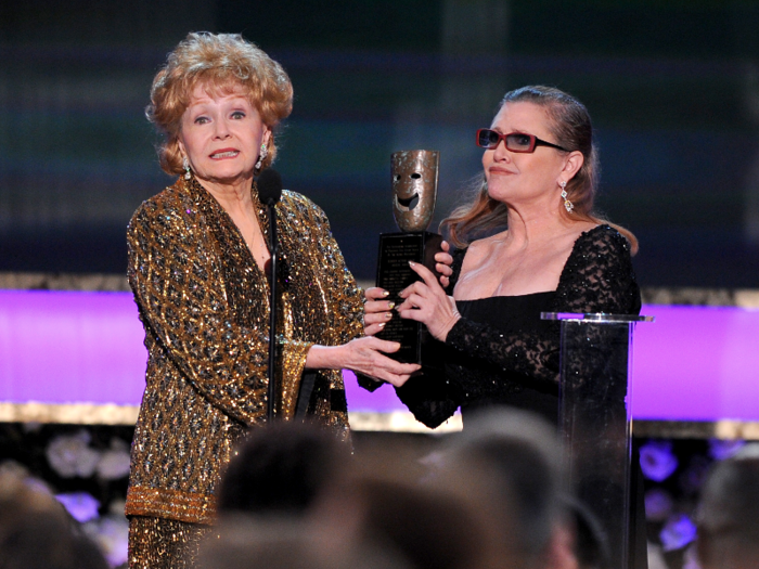 Fisher presents Reynolds with the Screen Actors Guild Life Achievement Award at the 21st annual Screen Actors Guild Awards on Sunday, Jan. 25, 2015, in Los Angeles.