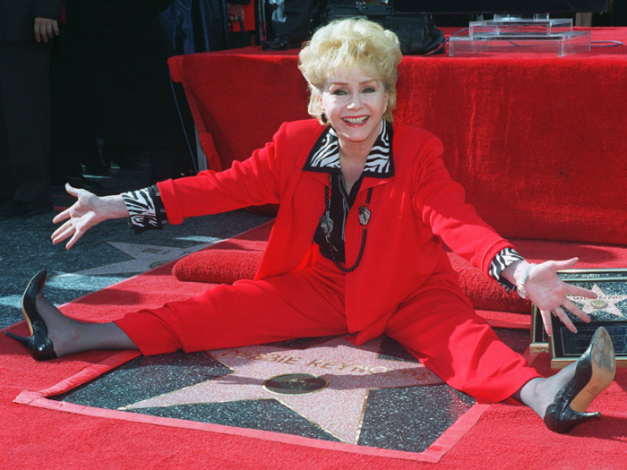 Reynolds poses with her second star on the Hollywood Walk of Fame, Monday, Jan. 13, 1997, in Hollywood.