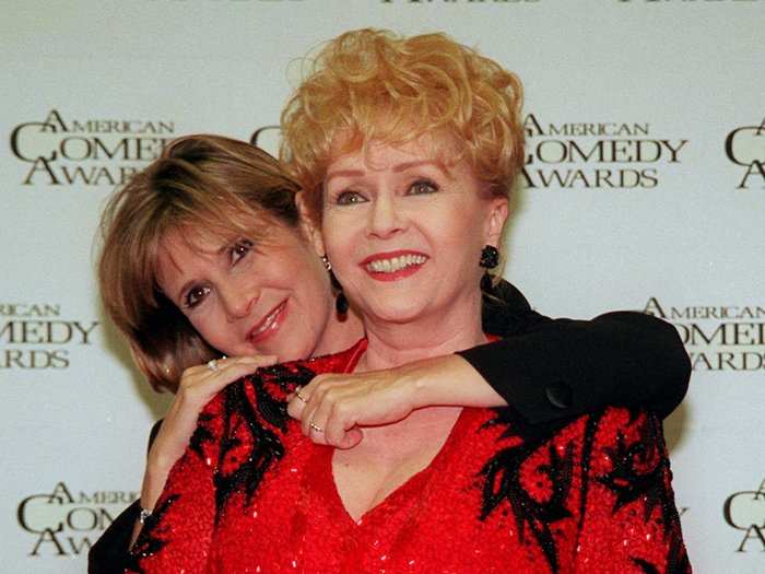 Carrie Fisher hugs her mother backstage at the 11th annual American Comedy Awards in Los Angeles on Feb. 9, 1997. Reynolds was awarded a Lifetime Achievement Award at the ceremony.