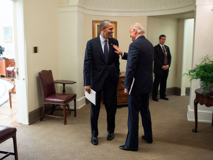 Obama and Biden speak in the hallway outside the Oval Office following a meeting on November 26, 2012.