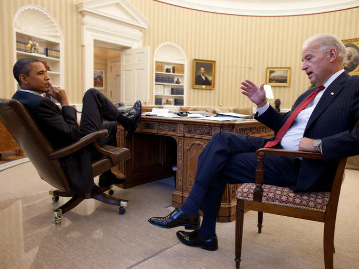 Obama listens to Biden in the Oval Office.