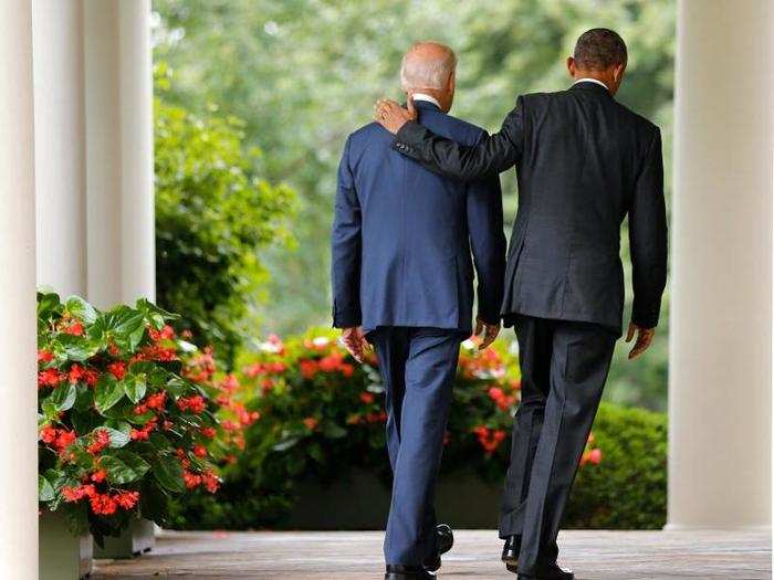 Obama and Biden walk back to the Oval Office after speaking about the US Supreme Court ruling to uphold the nationwide availability of tax subsidies under Obamacare.