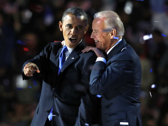 Obama gestures with Biden after his election-night victory speech in Chicago on November 6, 2012.