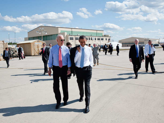 Obama walks across the tarmac with Vice President Joe Biden before departing from Fort Campbell, Kentucky.