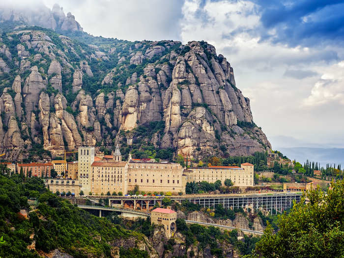 Take a cable car up to the Santa Maria de Montserrat, on the side of the Montserrat mountain a short distance outside of Barcelona, Spain.