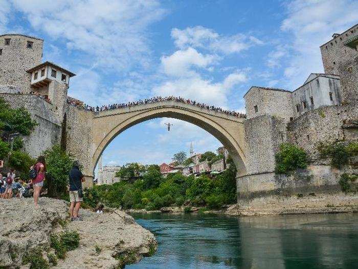 Visit Mostar bridge in southern Bosnia and Herzegovina and do not be surprised to see locals and brave tourists throwing themselves off its 79-foot-tall peak.