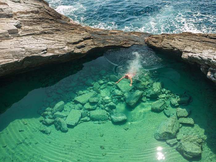 Swim in the translucent water of Giola, a natural rock pool in the region of Astris on the Greek island of Thassos.