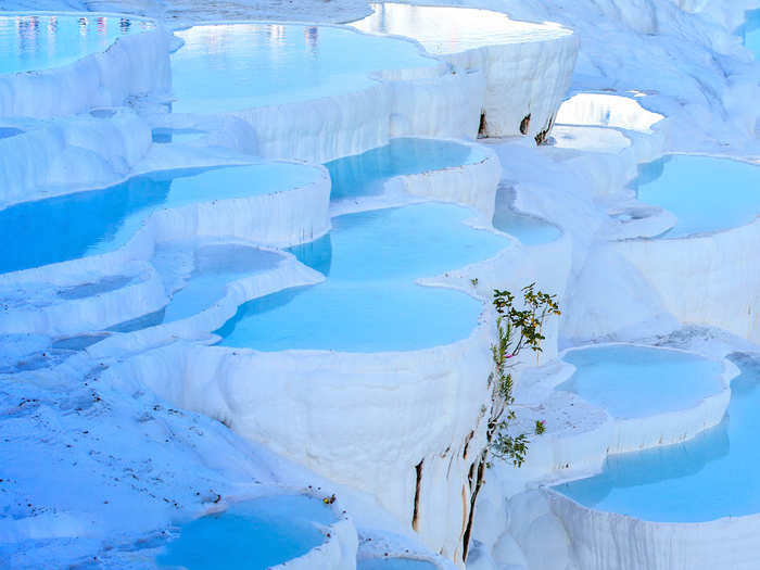 Dip into one of the stunning terraced thermal pools filled with minerals in Pamukkale, Turkey.